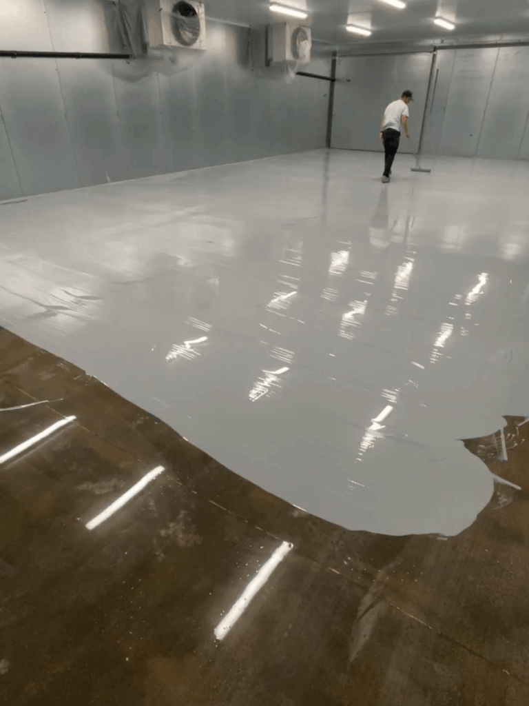Applying commercial epoxy build coat to food processing facility floor