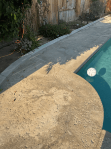 Deteriorated salt water pool deck with extensive cracking in Bakersfield residential home