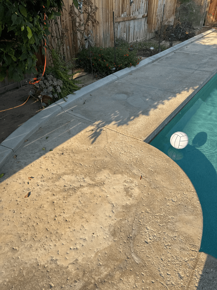 Deteriorated salt water pool deck with extensive cracking in Bakersfield residential home