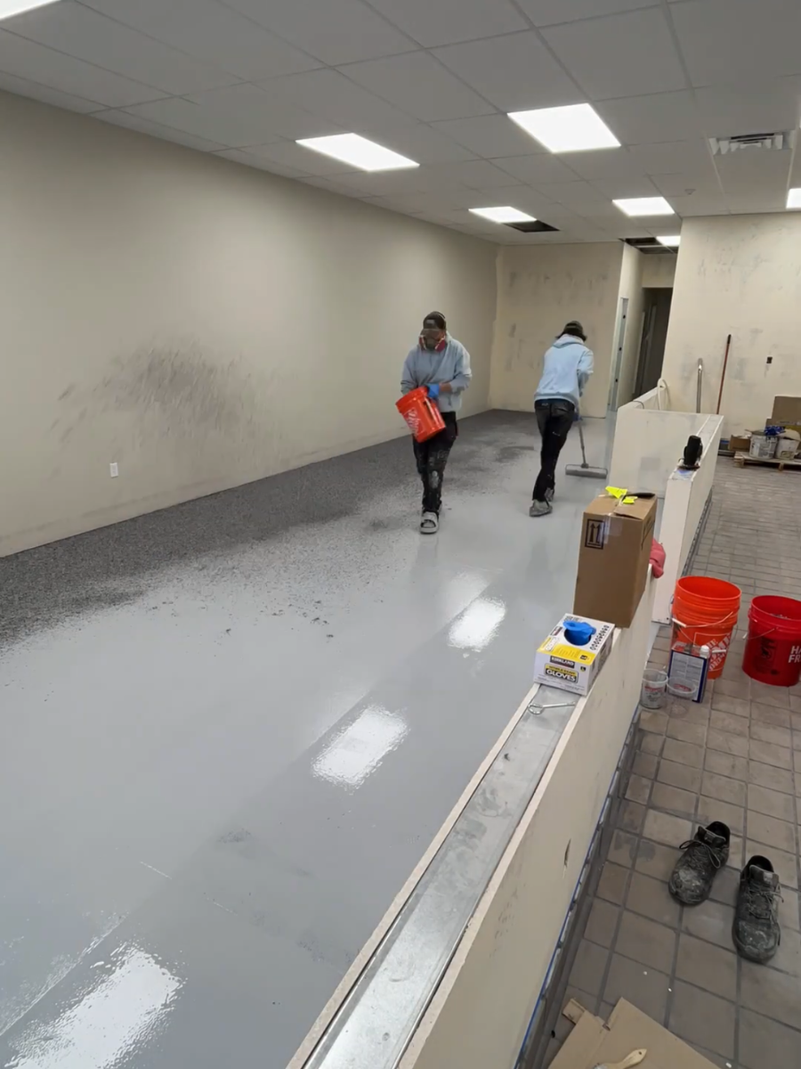 Husky Coatings crew rolling the epoxy basecoat and broadcasting flake at a juice bar in Bakersfield, CA
