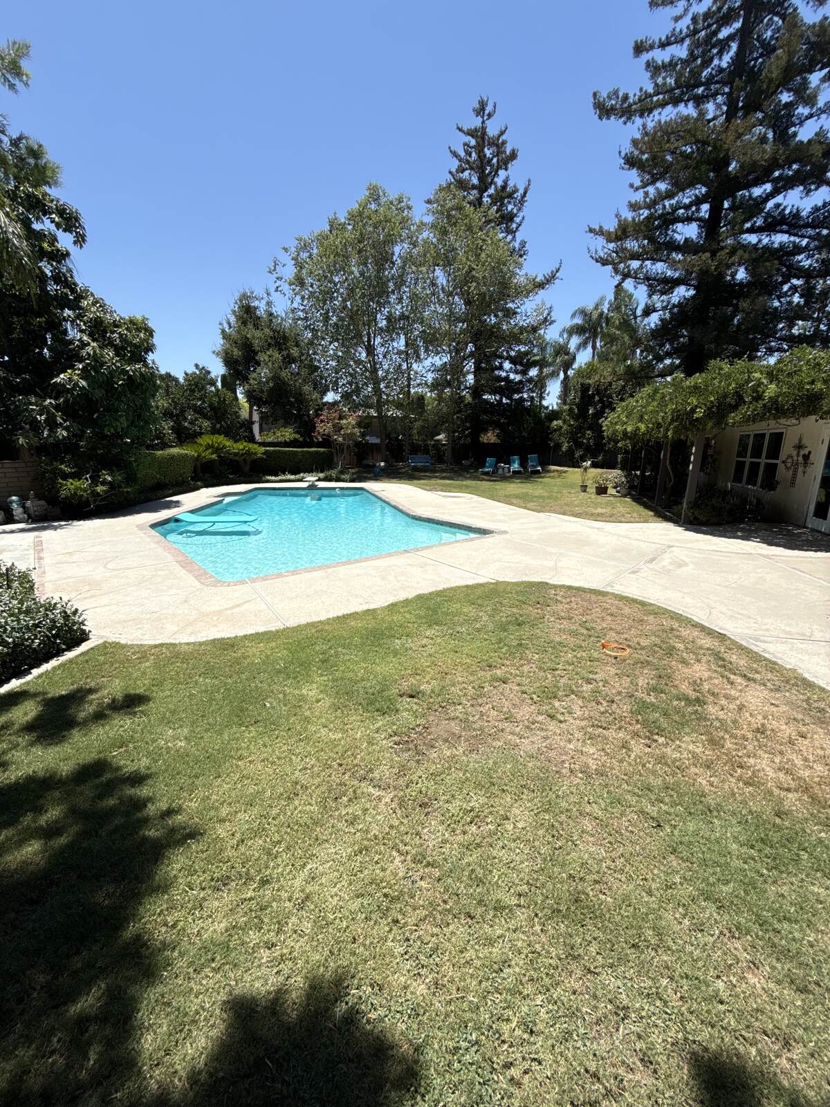 Worn concrete before pool deck coating in Bakersfield, CA