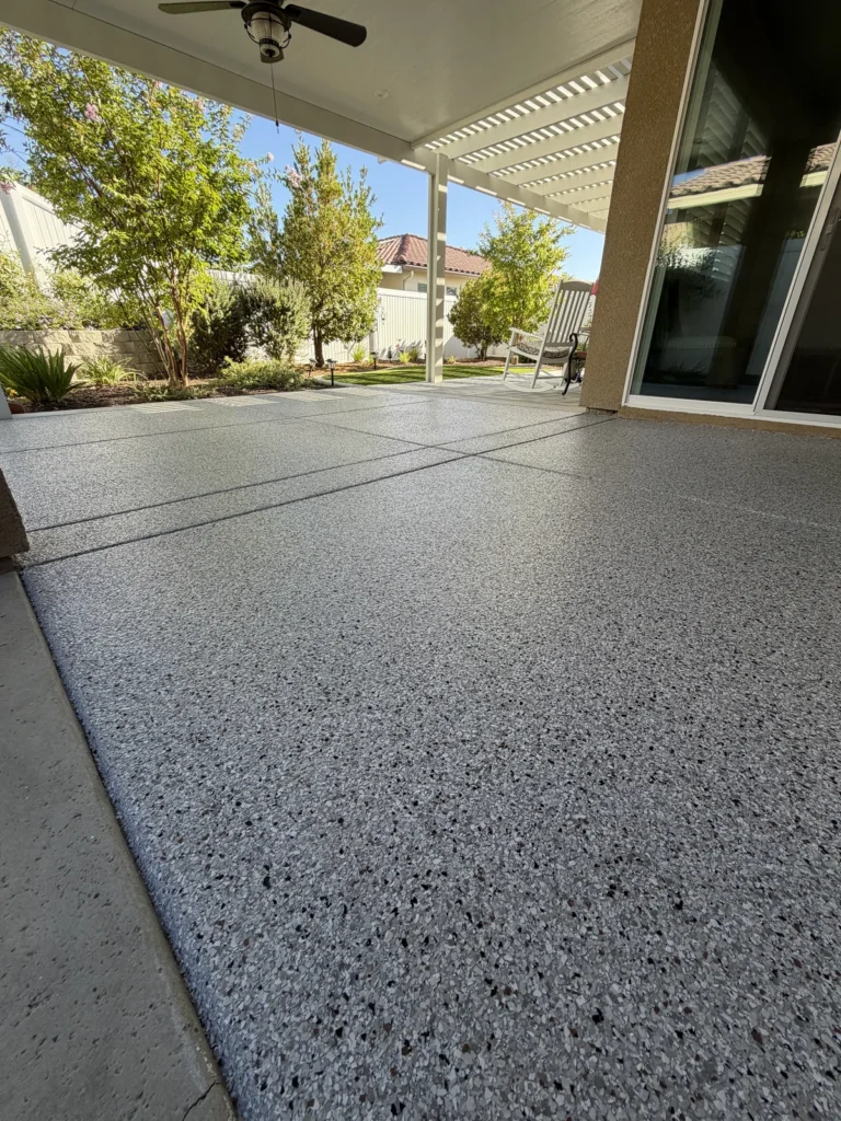 California Grey flake patio coating beneath a lattice pergola in Bakersfield, CA