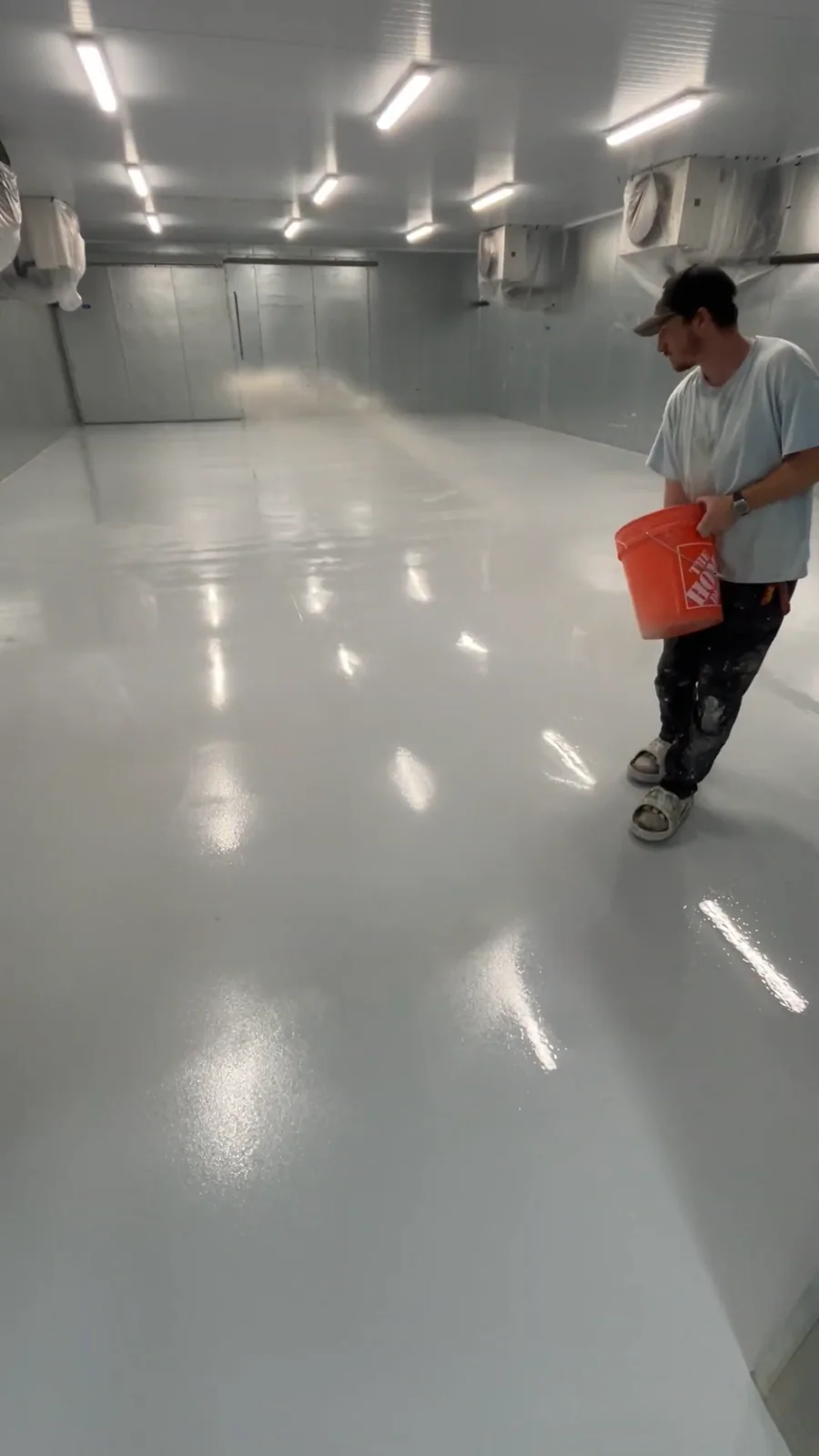 Husky Coatings crew broadcasting sand into the coating in a commercial freezer room in Bakersfield, CA