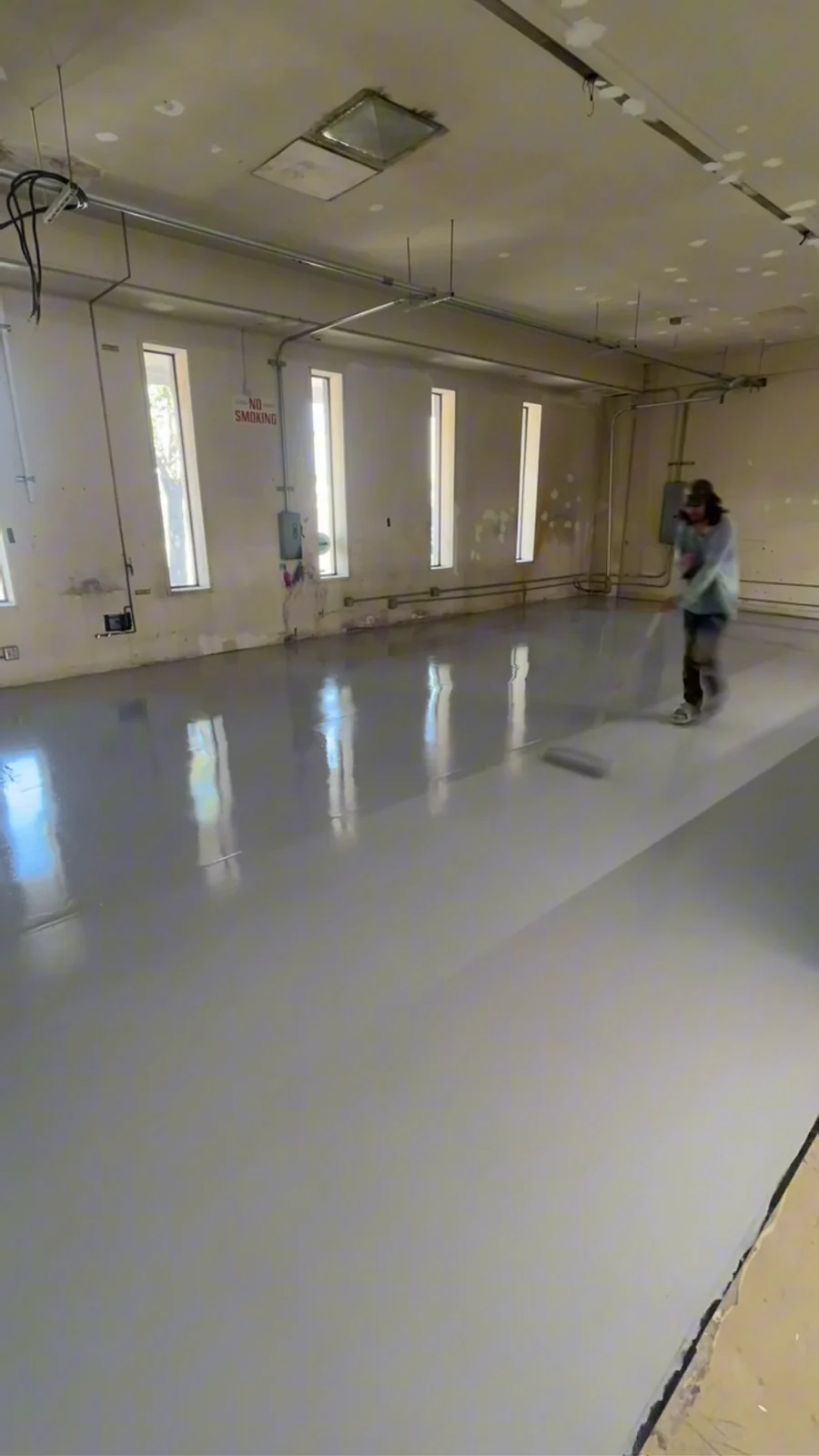 Urethane topcoat going down over a solid color commercial floor coating in Bakersfield, CA
