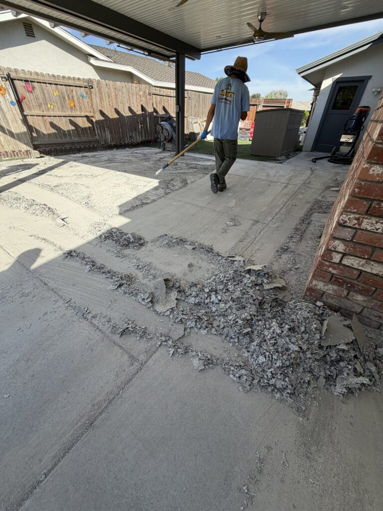 removing a failed patio floor coating in Bakersfield CA — coming off in sheets